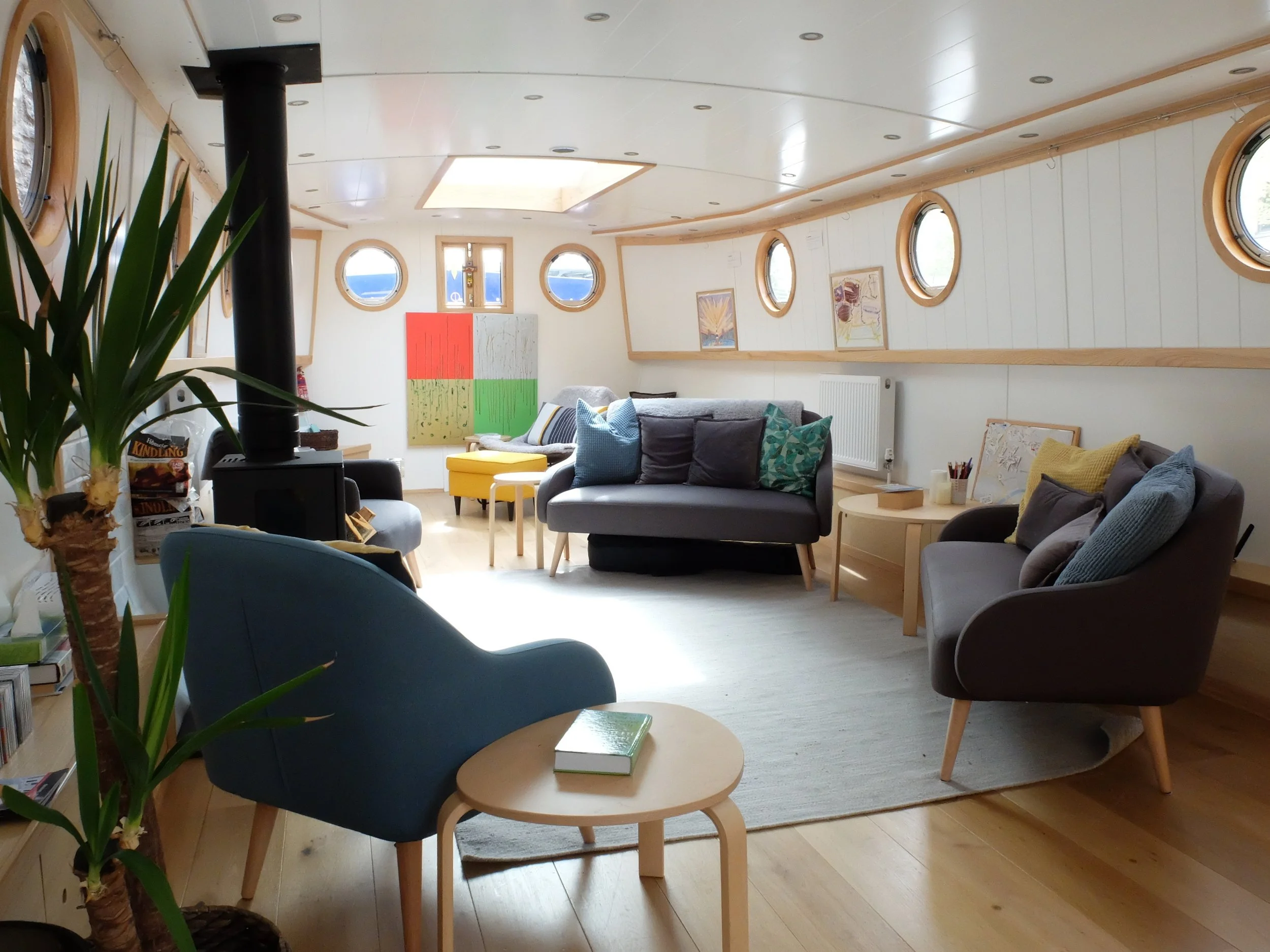 Inside The Prayer Barge — wood-burning stove and quiet seating
